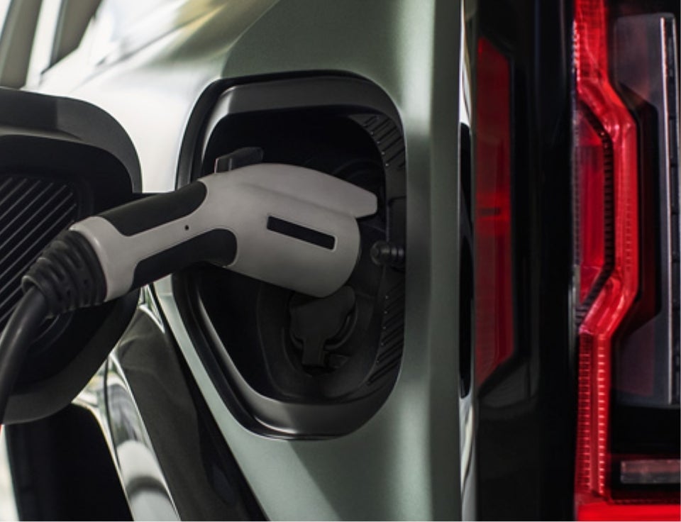 Close up of charging port with charger plugged in on a GMC Hummer EV SUV - Edwards Automotive GMC in IRON MOUNTAIN MI