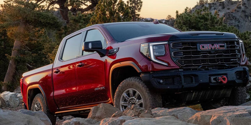 Close-up view of the durable, high-quality tire fitted on a 2026 GMC Sierra 1500, highlighting the deep tread pattern and rugged construction.